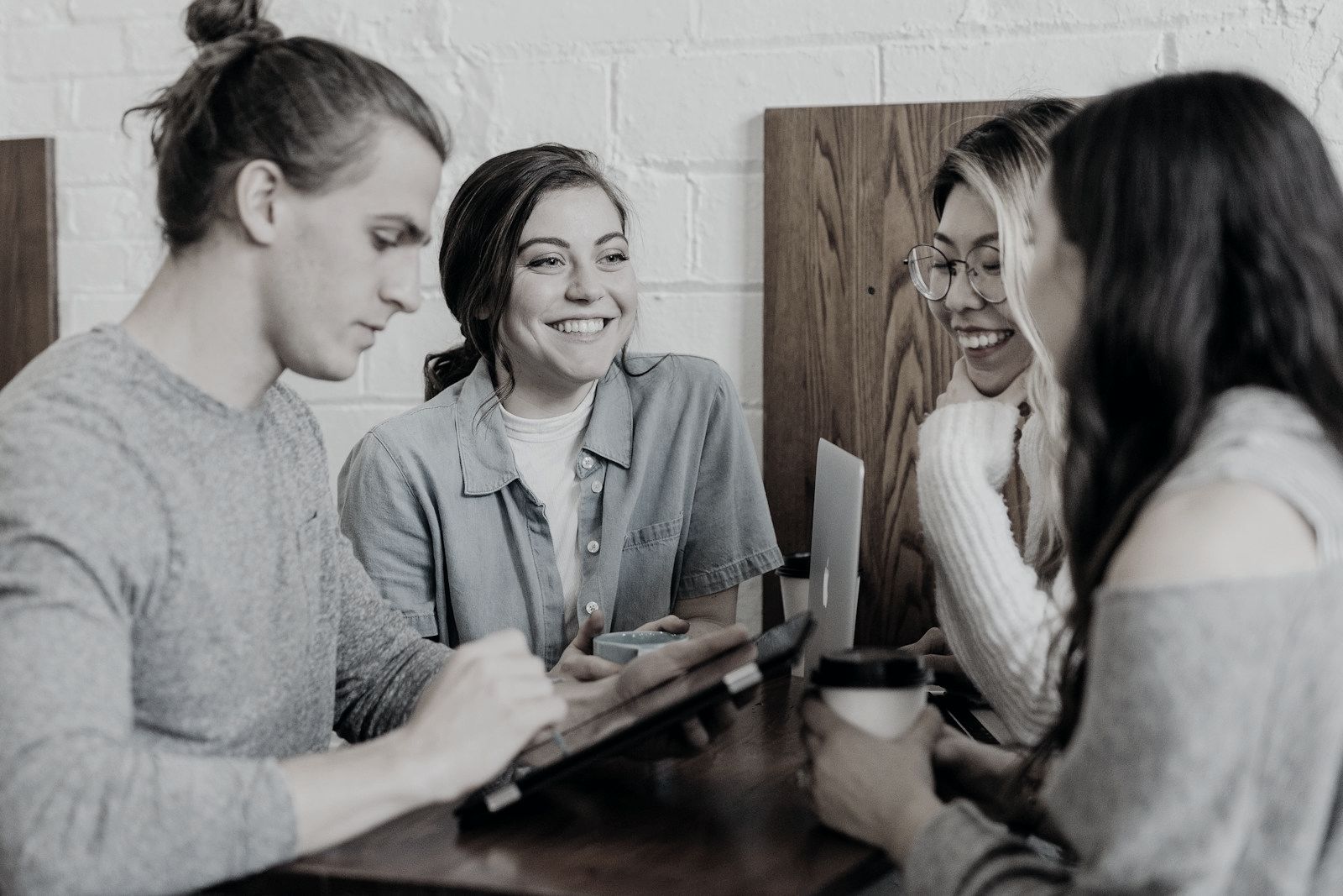 Four students talking around a table