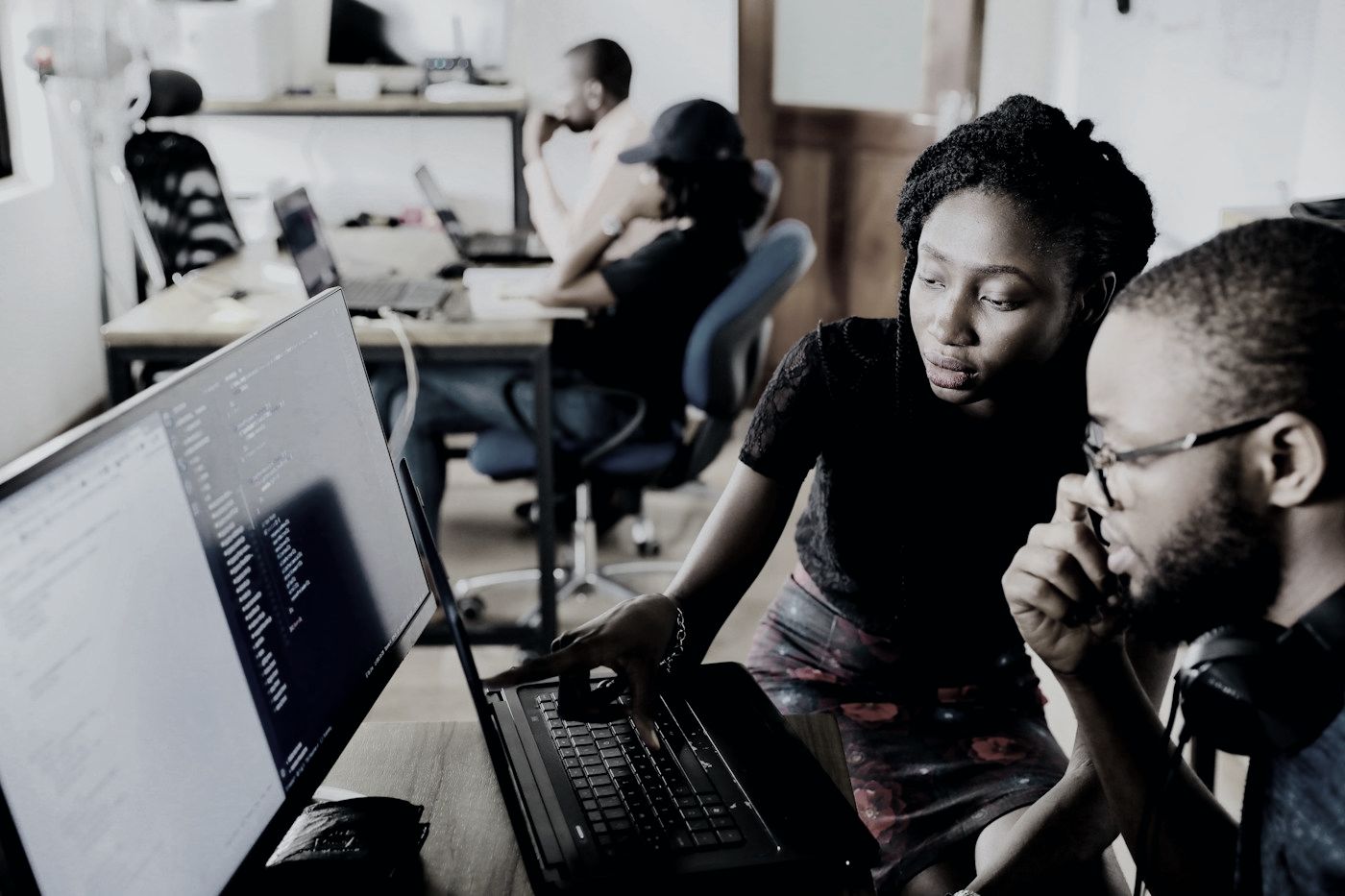 A mentor and a student reviewing a printed statement of purpose draft together at a table